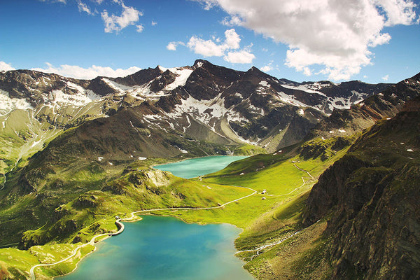 Blue Lake among Mountains and Snowy Peaks